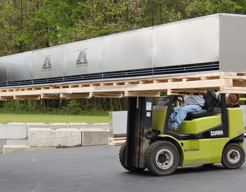Forklift carrying a large air curtain blower