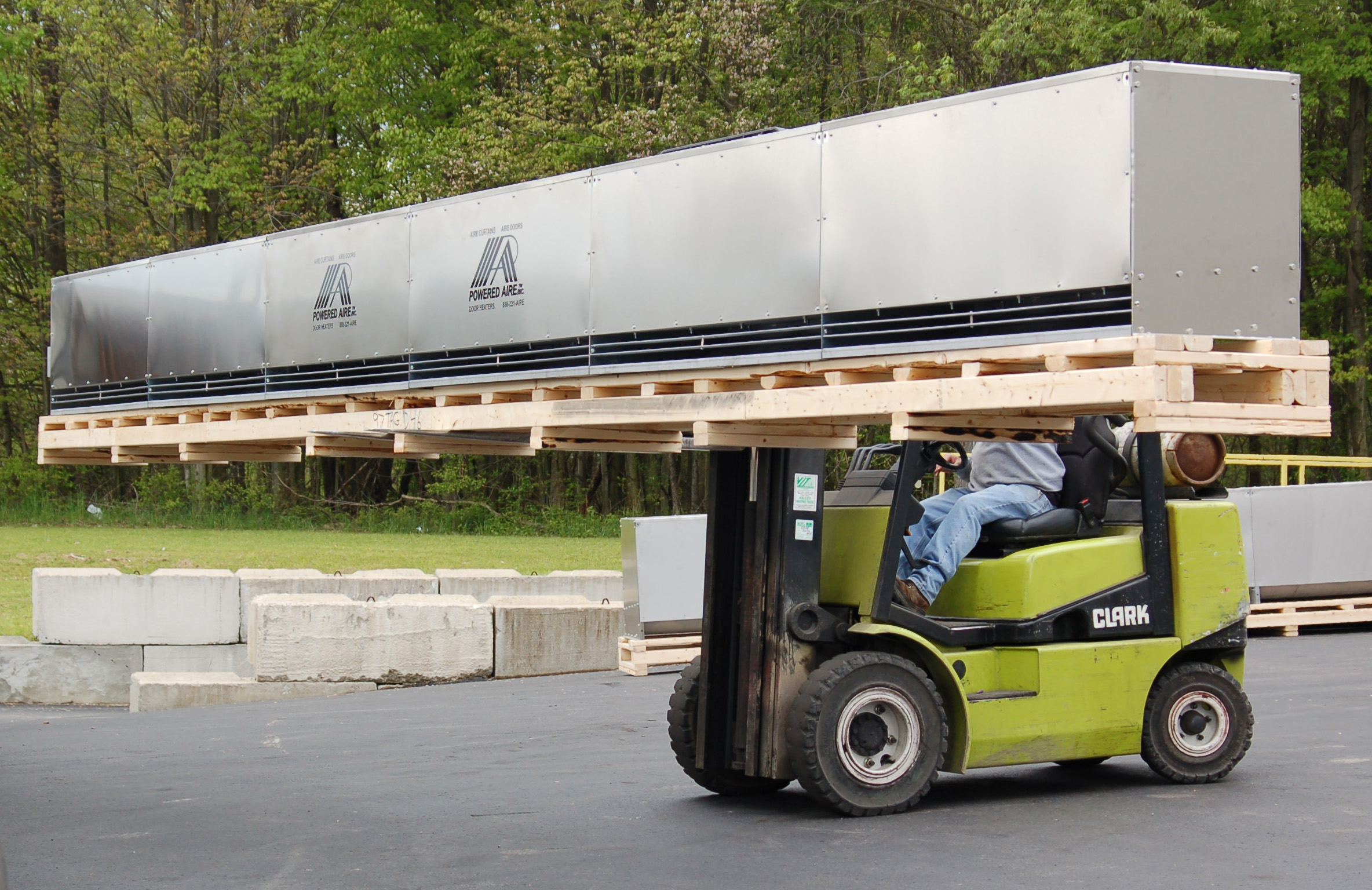 Forklift carrying a large air curtain blower